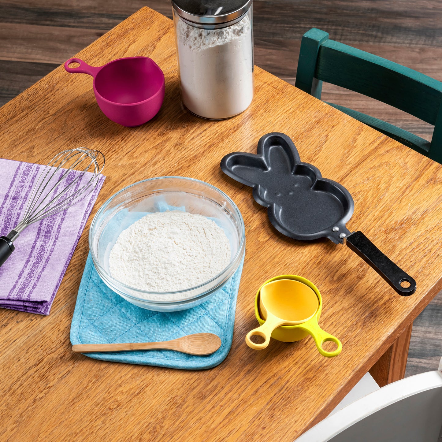 Pancake mix and skillet from the set with various kitchen utensils and supplies