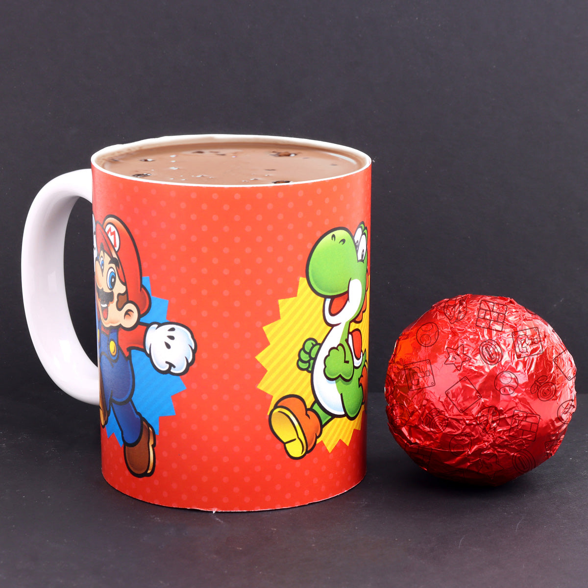 mug filled with hot chocolate next to wrapped hot chocolate bomb